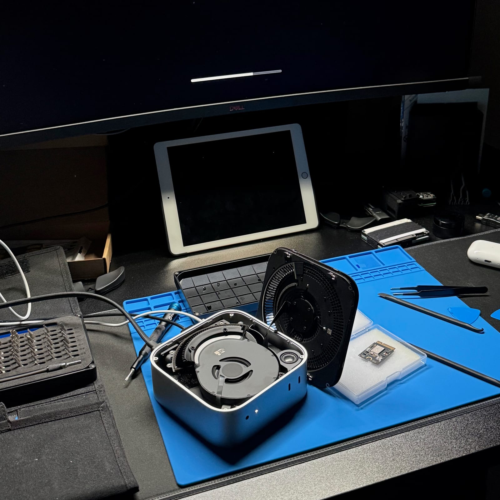 DFU restore in progress with the M4 Mac mini open on the desk