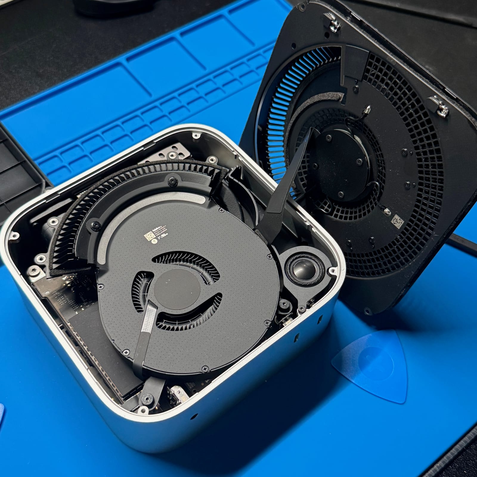 Open M4 Mac mini with the fan and inner plate exposed during the SSD upgrade